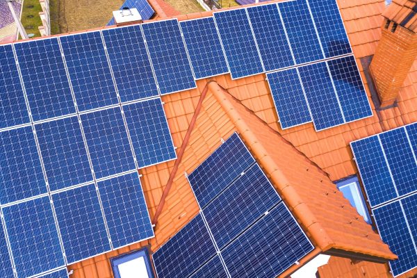 aerial-top-view-of-new-modern-residential-house-cottage-with-blue-shiny-solar-photo-voltaic-panels.jpg